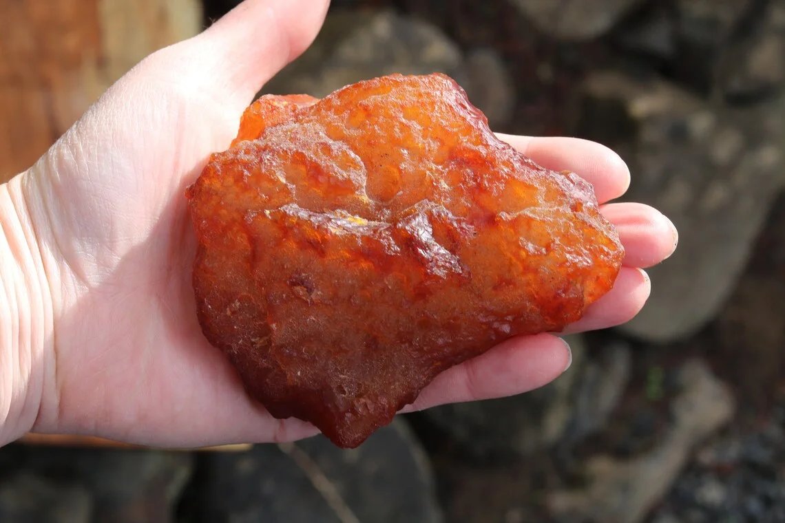 Tumbled grade carnelian agate nugget in hand